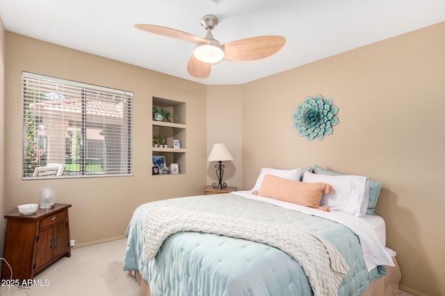 bedroom with ceiling fan, baseboards, and carpet