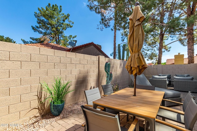 view of patio / terrace featuring fence and outdoor dining space