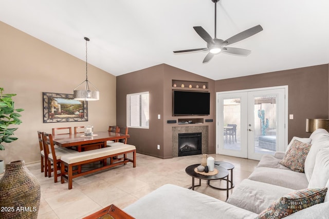 living area with light tile patterned floors, french doors, baseboards, high vaulted ceiling, and ceiling fan