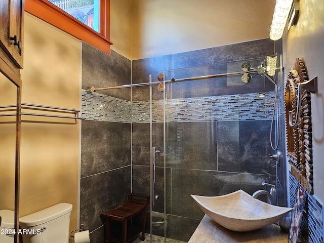 bathroom featuring an enclosed shower, tile walls, and toilet