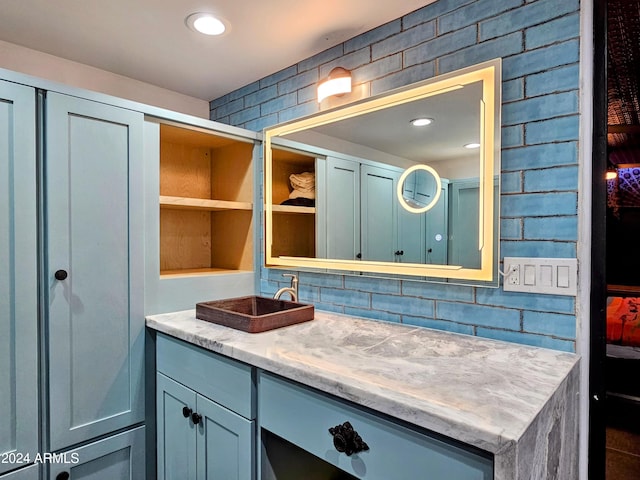 bathroom with vanity and tasteful backsplash