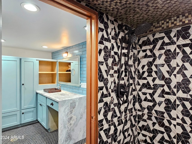 bathroom with vanity, tile patterned floors, decorative backsplash, and walk in shower