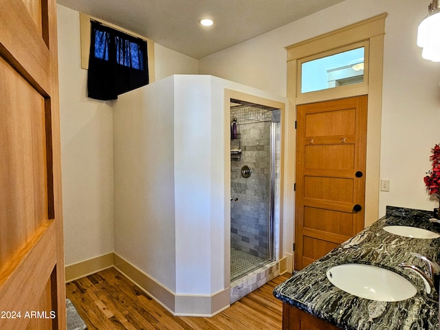 bathroom featuring double sink vanity, hardwood / wood-style floors, and an enclosed shower