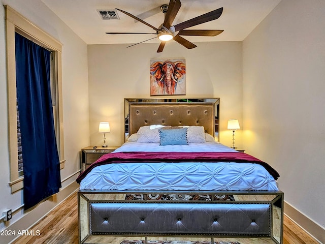 bedroom with ceiling fan and hardwood / wood-style floors