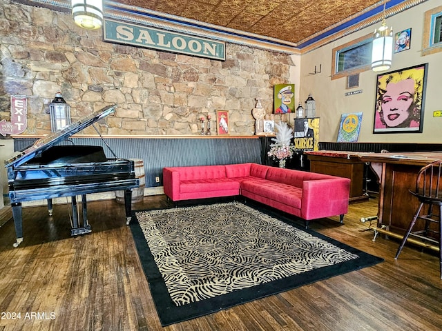 interior space featuring bar, crown molding, and hardwood / wood-style floors