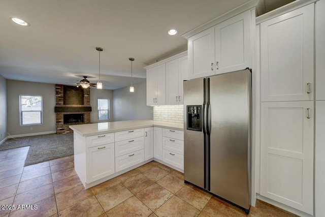 1010 N Osprey Ct, Gilbert, AZ 85234 - kitchen with ceiling fan, stainless steel fridge with ice dispenser, open floor plan, a peninsula, and a fireplace