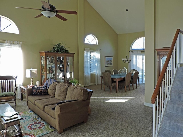 1010 N Osprey Ct, Gilbert, AZ 85234 - carpeted living room featuring stairway, ceiling fan with notable chandelier, and high vaulted ceiling