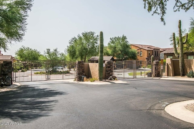 20750 N 87th St Unit 2103, Scottsdale, AZ 85255 - view of asphalt street with a gate, a gated entry, curbs, and sidewalks
