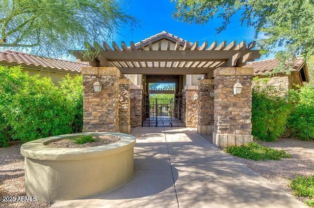 20750 N 87th St Unit 2103, Scottsdale, AZ 85255 - doorway to property featuring a gate, a tile roof, stone siding, and stucco siding