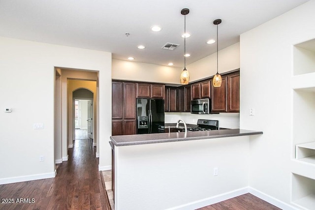 20750 N 87th St Unit 2103, Scottsdale, AZ 85255 - kitchen featuring stainless steel appliances, dark brown cabinetry, arched walkways, dark wood finished floors, and a peninsula