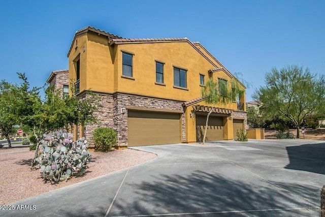 20750 N 87th St Unit 2103, Scottsdale, AZ 85255 - view of property with an attached garage, stucco siding, driveway, stone siding, and a tiled roof