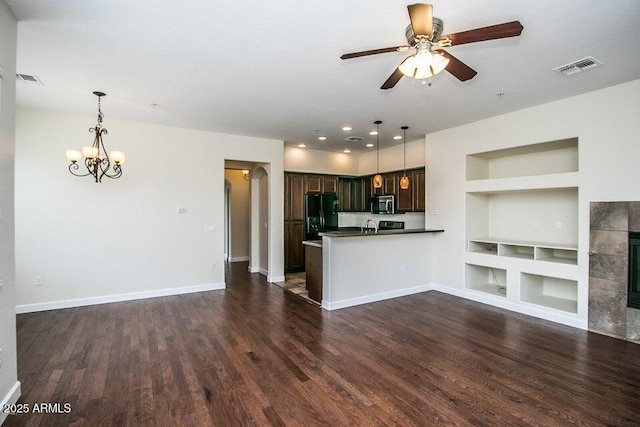 20750 N 87th St Unit 2103, Scottsdale, AZ 85255 - kitchen with stainless steel microwave, black refrigerator, built in shelves, open floor plan, and ceiling fan