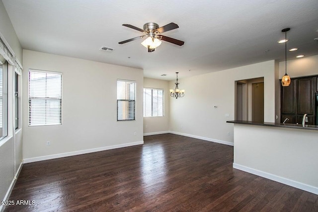 20750 N 87th St Unit 2103, Scottsdale, AZ 85255 - spare room featuring a chandelier, a ceiling fan, dark wood-style floors, baseboards, and a sink