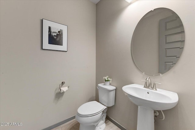 bathroom featuring toilet and tile patterned flooring