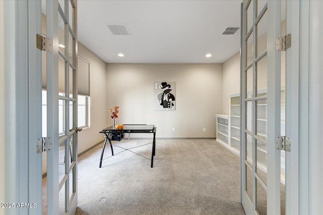 carpeted office space with french doors