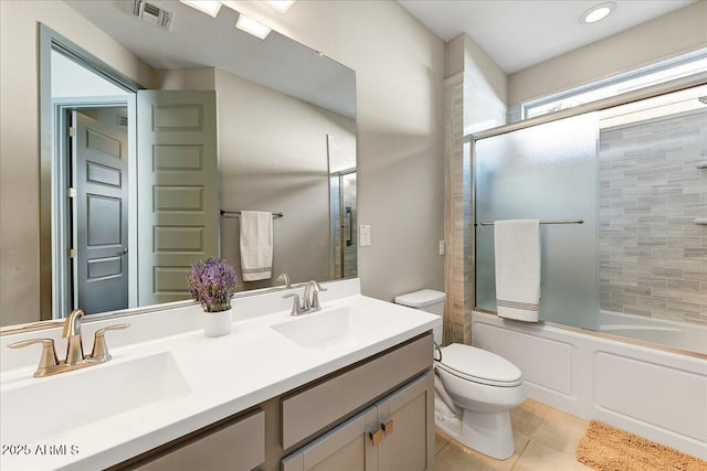 full bathroom featuring tile patterned floors, toilet, combined bath / shower with glass door, and vanity