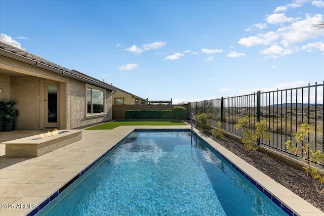 view of swimming pool featuring a patio area and an outdoor fire pit