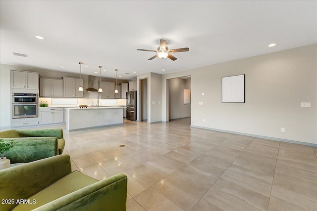 tiled living room with sink and ceiling fan