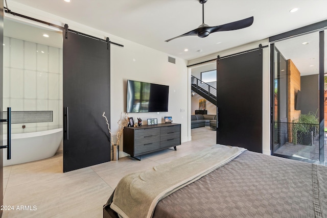 bedroom with a barn door, access to outside, light tile patterned floors, and ceiling fan