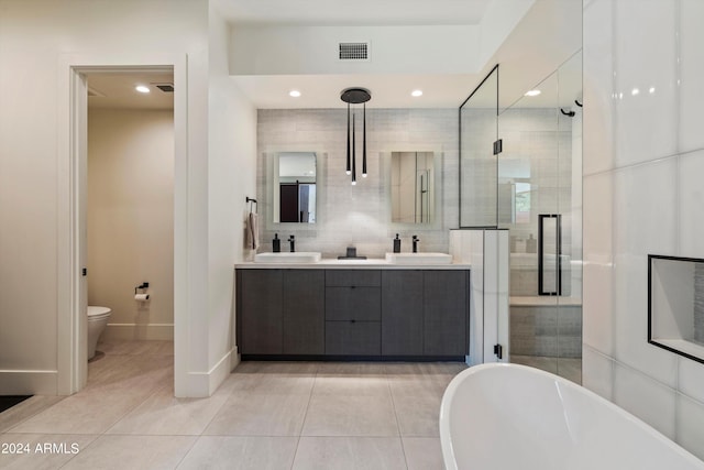 full bathroom featuring vanity, plus walk in shower, tile patterned flooring, and toilet