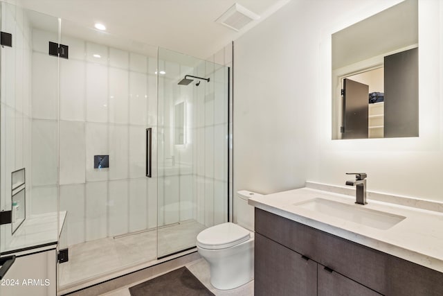 bathroom with vanity, toilet, a shower with door, and tile patterned floors