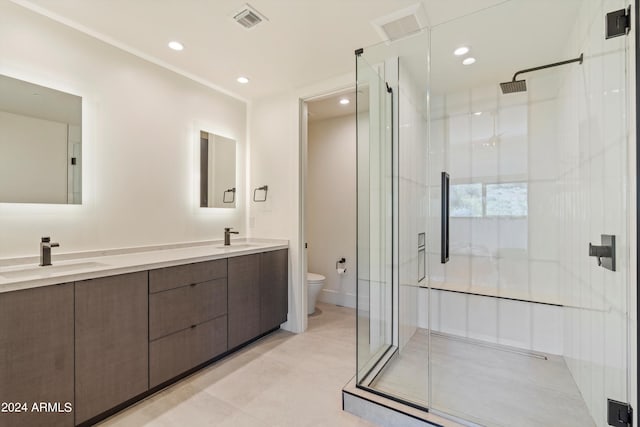 bathroom with walk in shower, vanity, and toilet