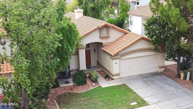 mediterranean / spanish-style home with a garage