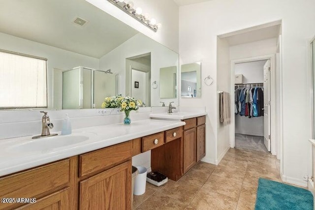 bathroom featuring vanity, a shower with shower door, and vaulted ceiling