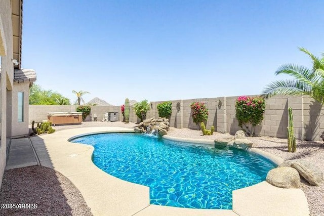 view of swimming pool featuring a patio area, pool water feature, and a hot tub