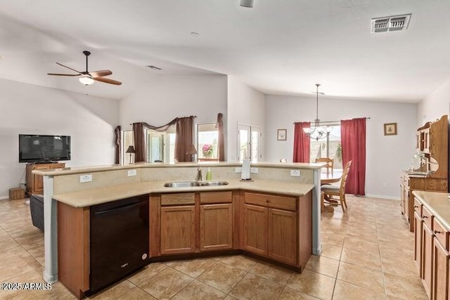 kitchen with pendant lighting, dishwasher, lofted ceiling, sink, and an island with sink