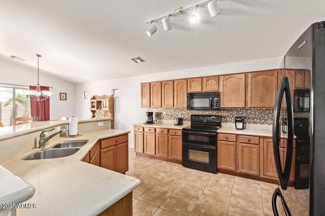 kitchen featuring sink, a chandelier, lofted ceiling, decorative light fixtures, and black appliances