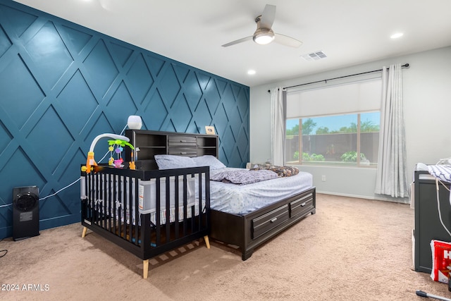 bedroom with light carpet and ceiling fan