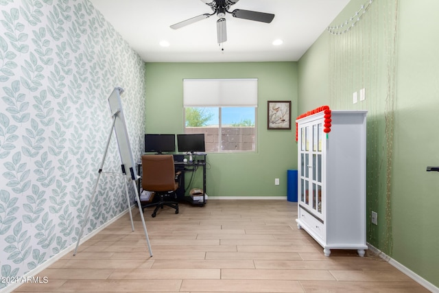 office with light hardwood / wood-style floors and ceiling fan