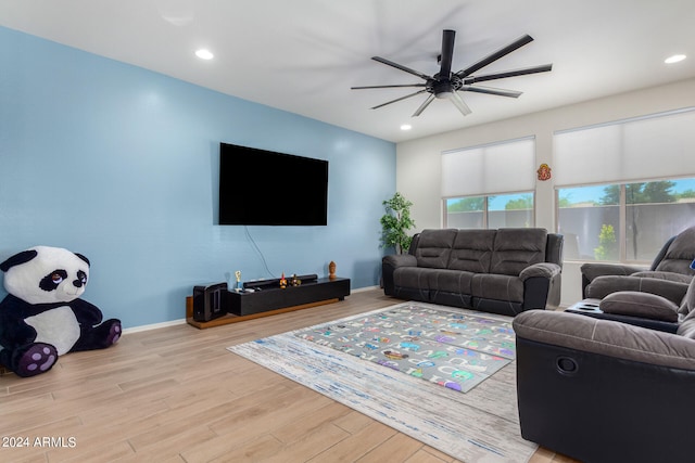 living room featuring ceiling fan and light wood-type flooring