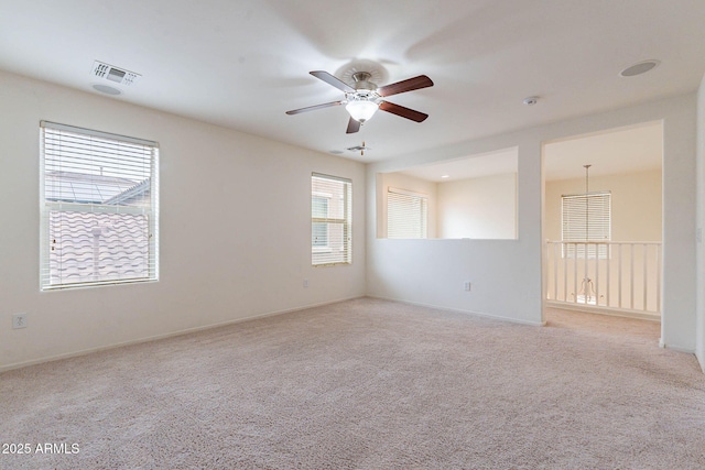 carpeted empty room featuring ceiling fan