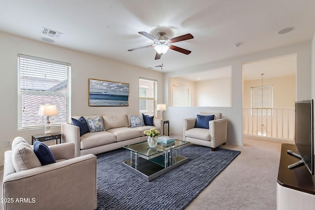 living room with ceiling fan and carpet flooring