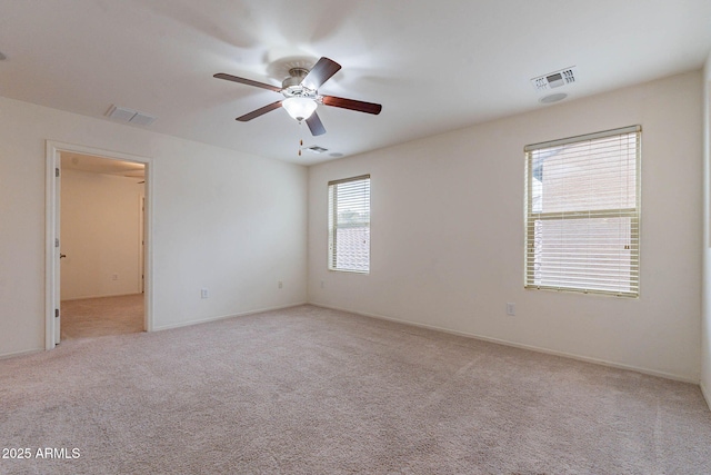 carpeted spare room featuring ceiling fan