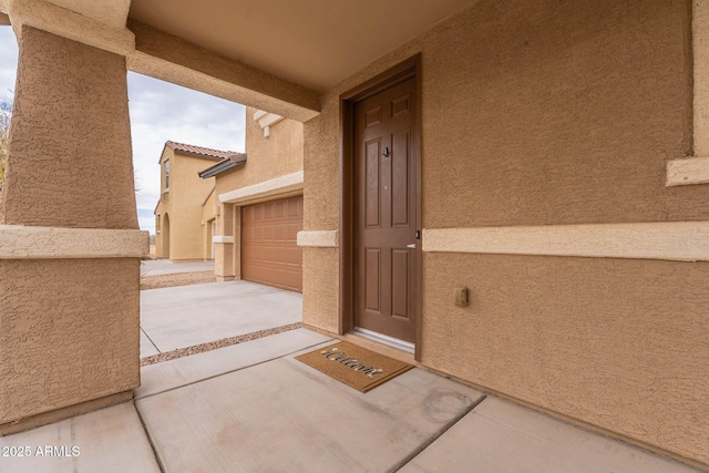 view of exterior entry with a garage