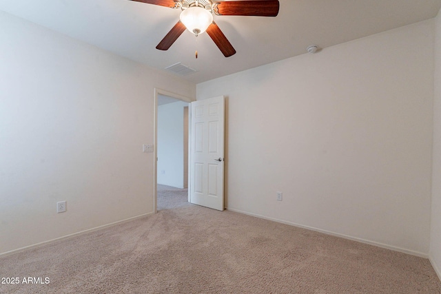 unfurnished room with light colored carpet and ceiling fan