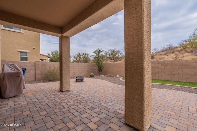 view of patio featuring grilling area and a fire pit