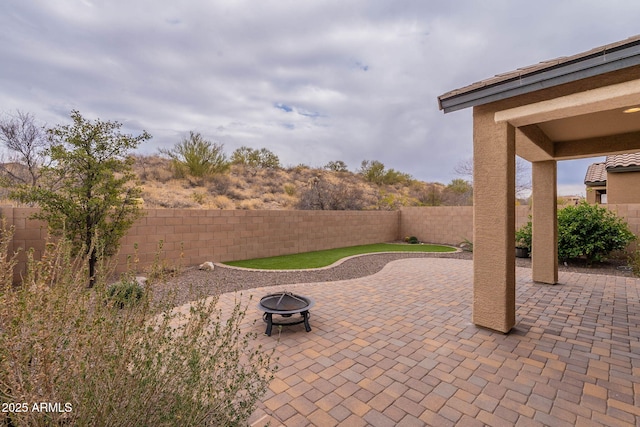 view of patio with a fire pit