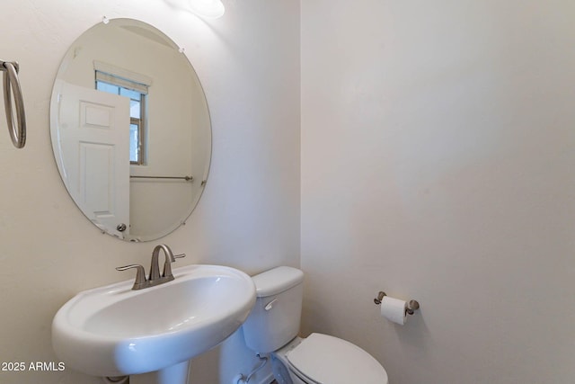 bathroom featuring toilet and sink