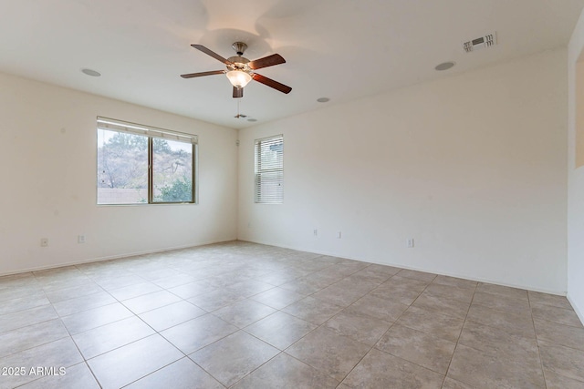 tiled empty room with ceiling fan