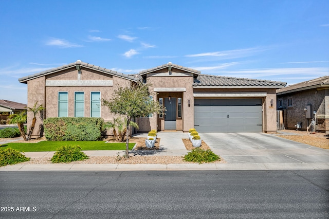 view of front of property with a tiled roof, stucco siding, driveway, and a garage