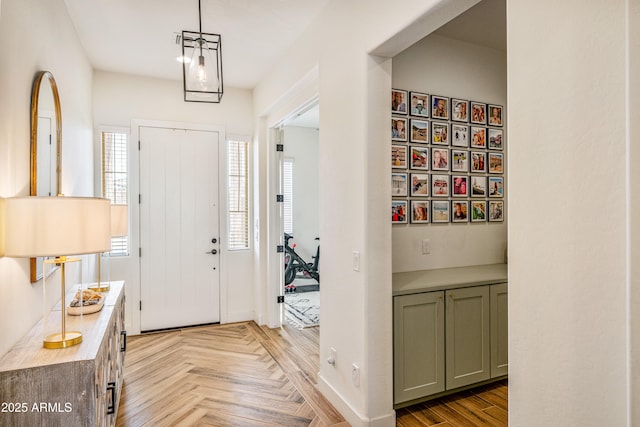 entrance foyer featuring parquet flooring and baseboards