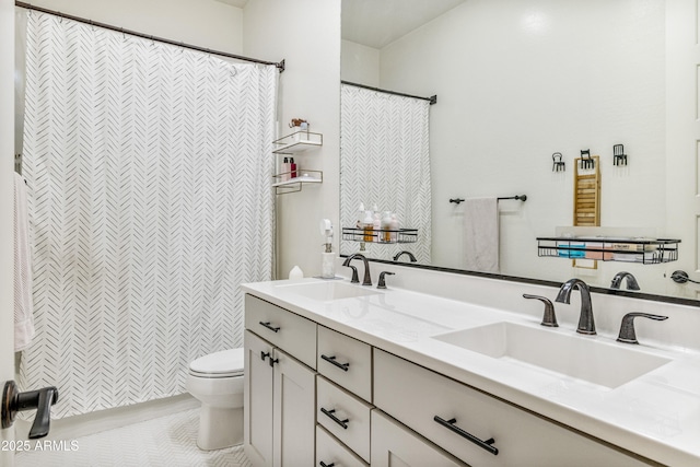 bathroom featuring curtained shower, double vanity, toilet, and a sink