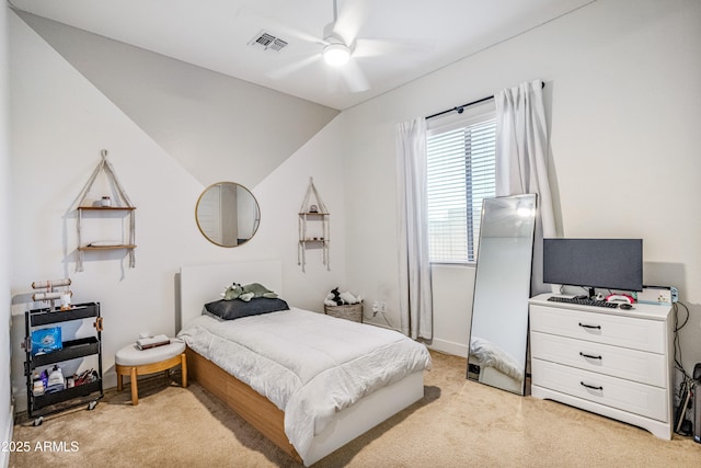 bedroom featuring vaulted ceiling, light colored carpet, visible vents, and ceiling fan