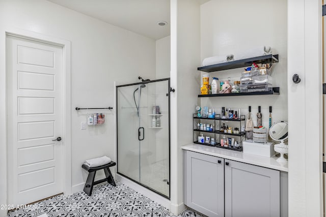 full bathroom with baseboards, a stall shower, and tile patterned flooring