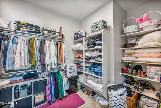 walk in closet with carpet