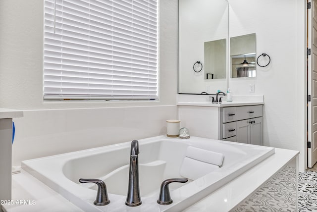 bathroom with vanity and a garden tub